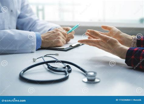 Medical Consultation Patient In Clinic Office Asks The Doctor For