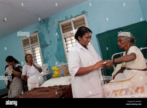 An Indian Nurse Attends A Patient In A Rural Health Care Clinic In