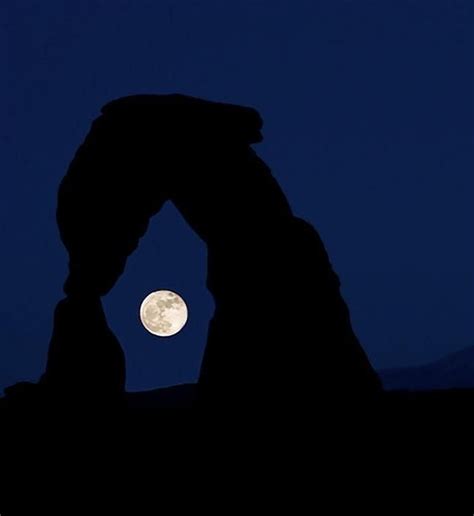 Full Moon Seen Through Delicate Arch Utah Usa Photo By Colby Brown