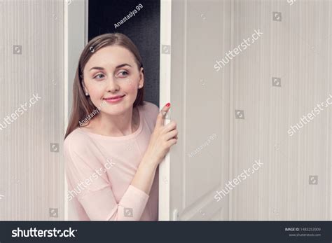 Beautiful Girl Spying On Door Portrait Foto De Stock 1483253909