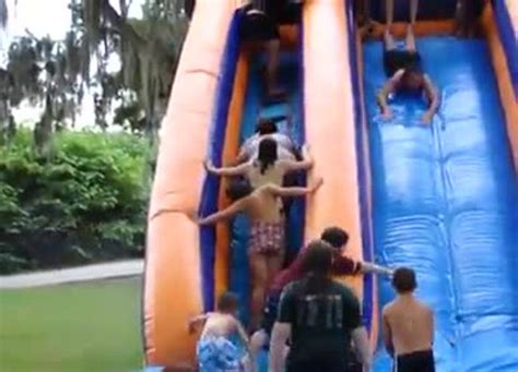 Guy Flies Off Rooftop Slip N Slide And Flies Over Inflatable Pool