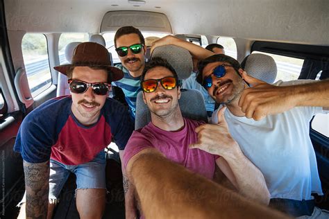 Group Of Young Men Friends With Sunglasses Taking A Selfie Inside A Van During A Road Trip