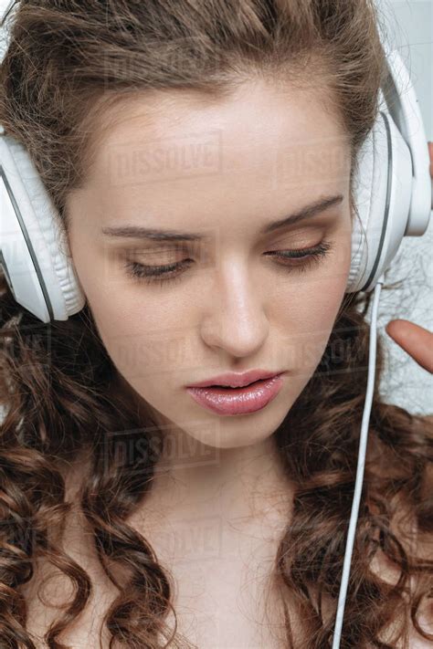 Portrait Of Attractive Young Woman Listening Music In Headphones