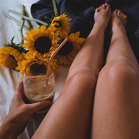 A Woman S Legs With Sunflowers And A Drink