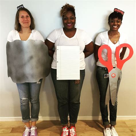 Three Women Standing Next To Each Other With Paper Cutouts In The Shape