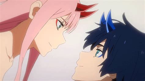 two anime characters looking at each other with blue eyes and pink hair on their heads