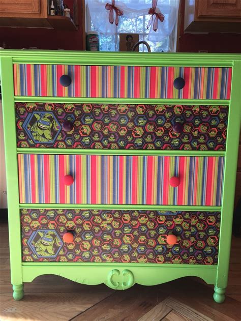 An Old Dresser Painted In Bright Colors
