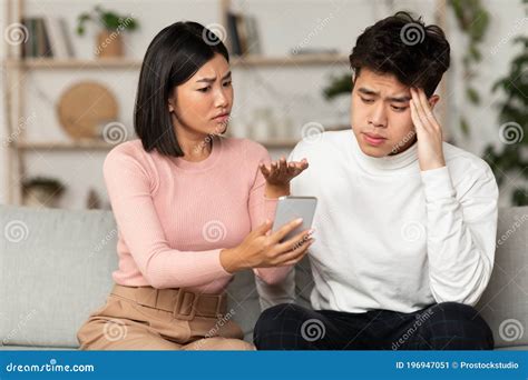 asian wife showing cheating husband his phone suspecting affair indoors stock image image of