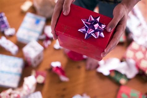 Photo of Close up of person giving a Christmas Present | Free christmas ...