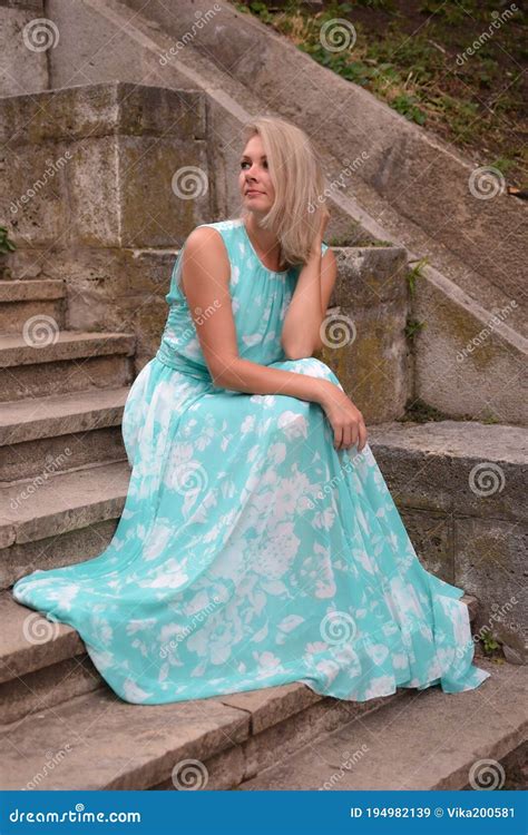 A Beautiful Woman In A Long Dress Sits On A Stone Outdoor Staircase Stock Image Image Of