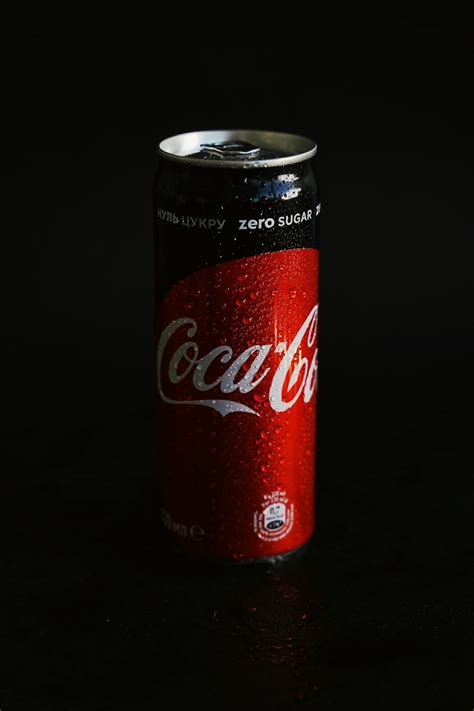 Coca Cola Can On Black Surface · Free Stock Photo