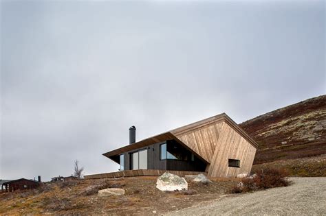 A Robust Hooded Cabin On Top Of A Mountain Withstands Norways Weather