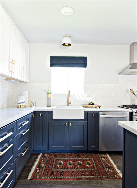 The kitchen uses simple paneled cabinets in pure white, with an overhead cabinet featuring glass cabinet doors. Having A Moment: Navy and White Kitchen Cabinets - Lauren ...