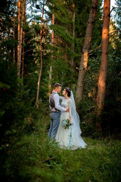 Premium Photo Beautiful Newlyweds Couple Walking In The Forest