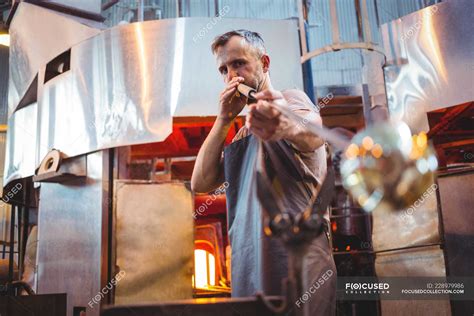Glassblower Shaping A Glass On The Blowpipe At Glassblowing Factory — Molten Mature Man Stock