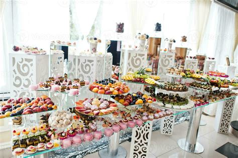 beautiful wedding candy bar with sweets fruits and food wedding banquet table 12866589 stock