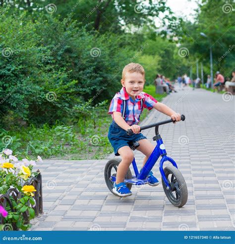 Little Boy Riding A Bike Ride In The Park Stock Photo Image Of Nature