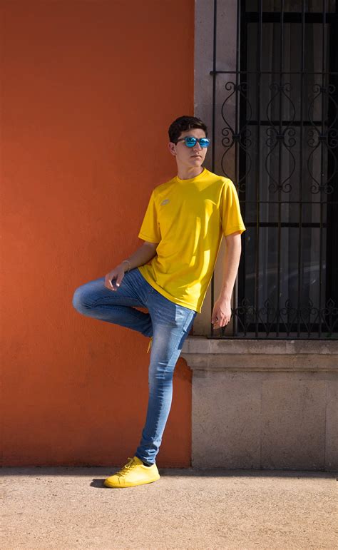 Man Wearing Yellow Crew Neck T Shirt And Blue Denim Jeans · Free Stock