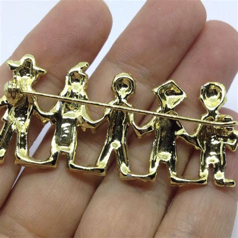signed ajc vintage 5 people of the world brooch pin nationality gold tone united we stand