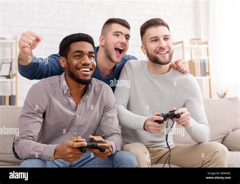 Diverse Mates Playing Video Games Holding Joysticks Stock Photo Alamy