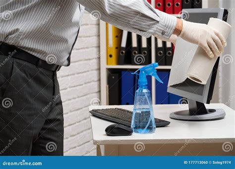 Concept Of Cleaning Or Disinfecting The Office A Businessman Cleans