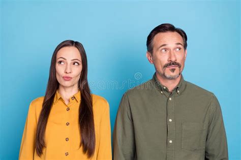 Photo Of Mature Minded Married Man And Woman Look Empty Space Idea Isolated On Pastel Blue Color