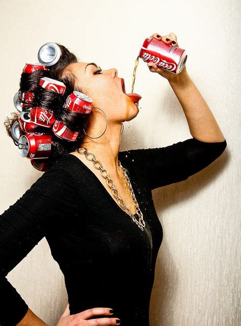 A Woman With Cans On Her Head Drinking From A Can