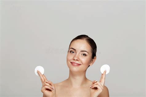 Beauty Portrait Of A Cheerful Young Topless Woman Removing Face Make Up