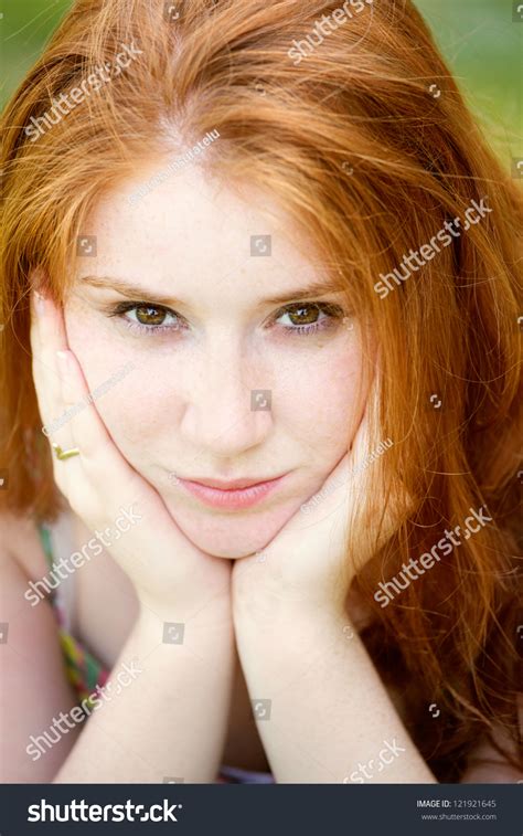Portrait Of A Beautiful 20 Year Old Redhead Woman Looking At Camera