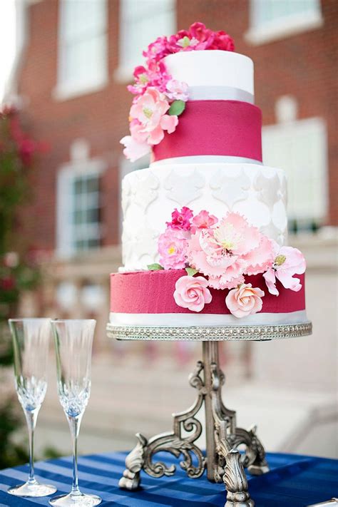 Beautiful Four Tier White And Hot Pink Wedding Cake With Flowers Photo