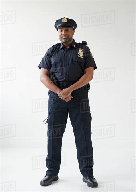 African American Policeman With Hands Clasped Stock Photo Dissolve