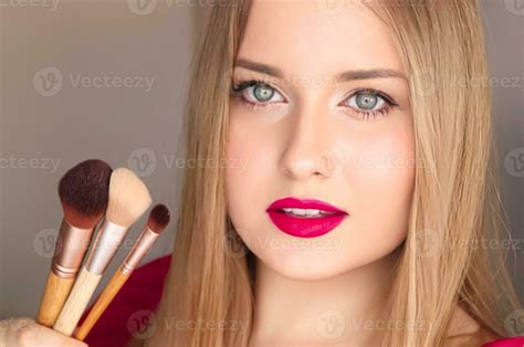beauty makeup and cosmetics face portrait of beautiful woman with make up brushes luxury