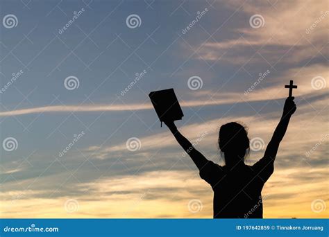 Women Standing Holding Holy Bible For Worshipping God At Sunset
