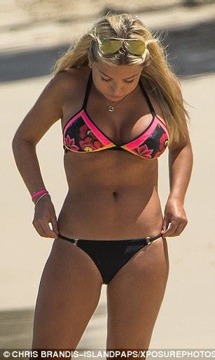 zara holland struggles to contain her assets in a skimpy floral bikini top in barbados daily