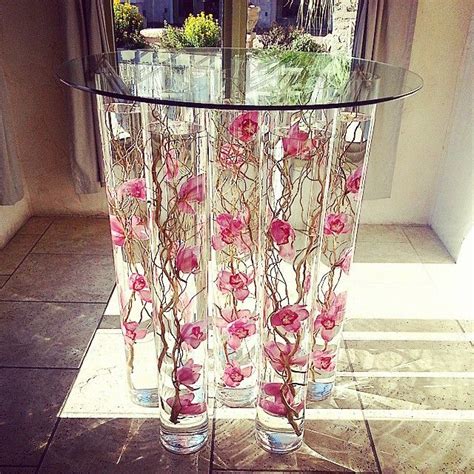 Cake Table With Tall Cylinder Vases With Submerged Orchids And Curly Willow And Glass Top