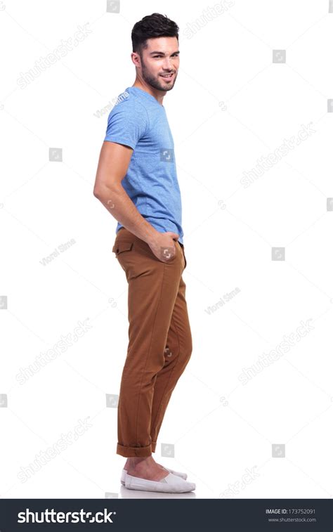 Side View Full Body Picture Of A Young Casual Man With Hands In His