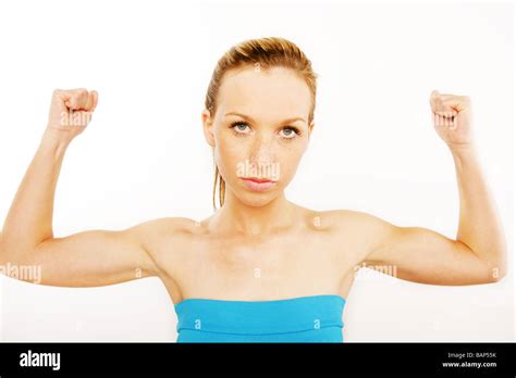 Well Toned Blonde Woman Flexing Her Bicep Muscles Stock Photo Alamy