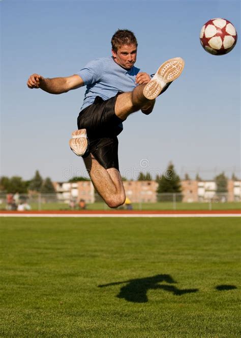 male soccer athletic male in the air kicking a soccer ball affiliate athletic soccer