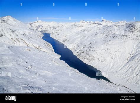 Aerial View Of The Alpine Lago Di Lei Surrounded By Snow Val Di Lei