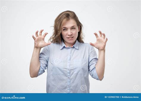Caucasian Woman Showing Her Wild Side Posing In Blue Shirt Growling At You And Gesturing A Claw