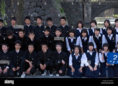 Group Of High School Students In Uniform Posing For Commemorative Stock