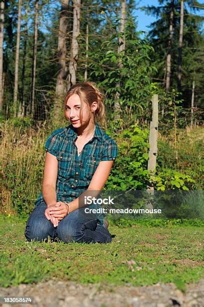 Young Beautiful Girl Kneeling On Ground Outside Smiling Copyspace Stock