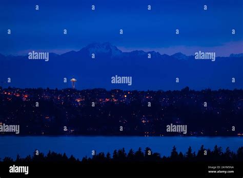 View Of Seattle Town At Night And Mountain Olympus On Background With