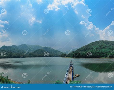 Reservoir With Surrounding Mountains And Beautiful Skies In Thailand