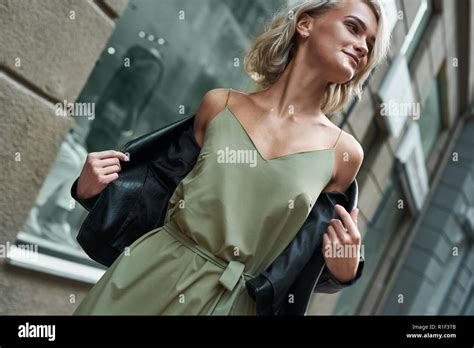 Fashion Young Stylish Woman Walking On The City Street Taking Off