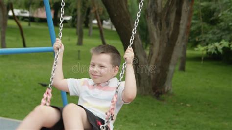 4k mom rides her son on a swing in the park in the summer stock footage video of cheerful