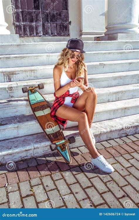 Sports Girl With Skateboard Longboard In Summer City Fashionable