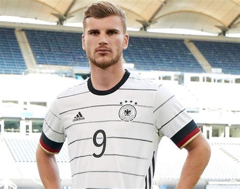 The rectangular logos feature the text uefa euro 2020 on the top, the city name above the text host city on the bottom (all in uppercase), the main tournament logo on the left predominantly white, the ball features black strokes with blue, neon and pink stripes. Adidas Euro 2020 Germany Home Kit Released | The Kitman