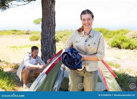 Outdoorsy Couple Setting Up Camp In The Countryside Stock Photo Image