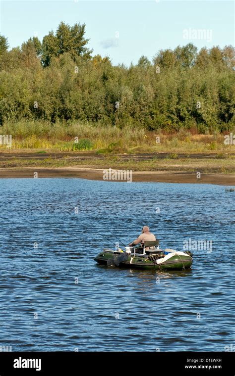 Alone Fisherman In A Boat On The Morning River Stock Photo Alamy